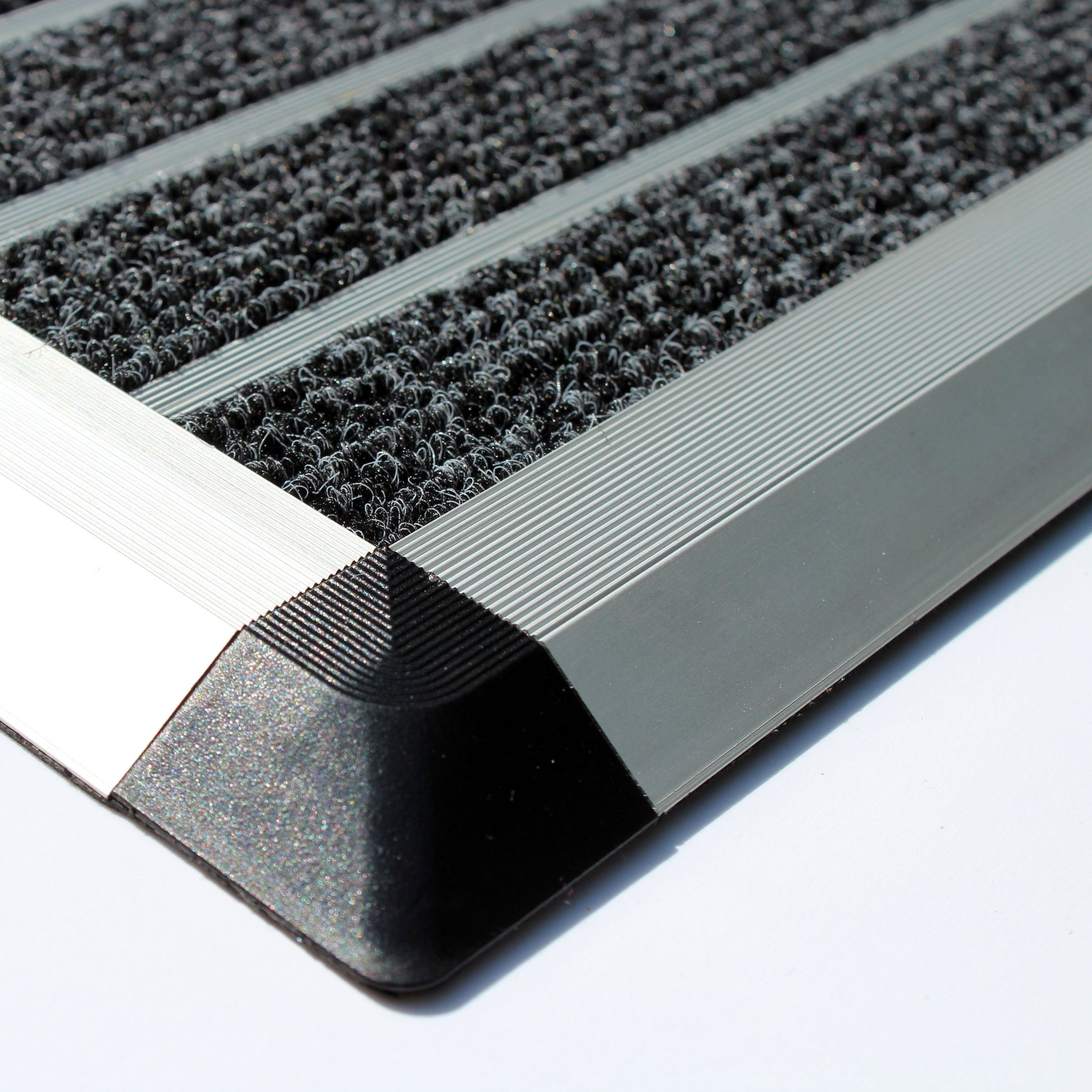 Corner close-up of Hometex Premium Aluminium Indoor Entrance Mat showing durable aluminium frame and dense fibre surface