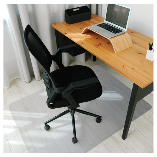 Lifestyle image of the Universal PVC Chair Mat – For Hard Floors under a caster-wheel office chair in a home office setup.