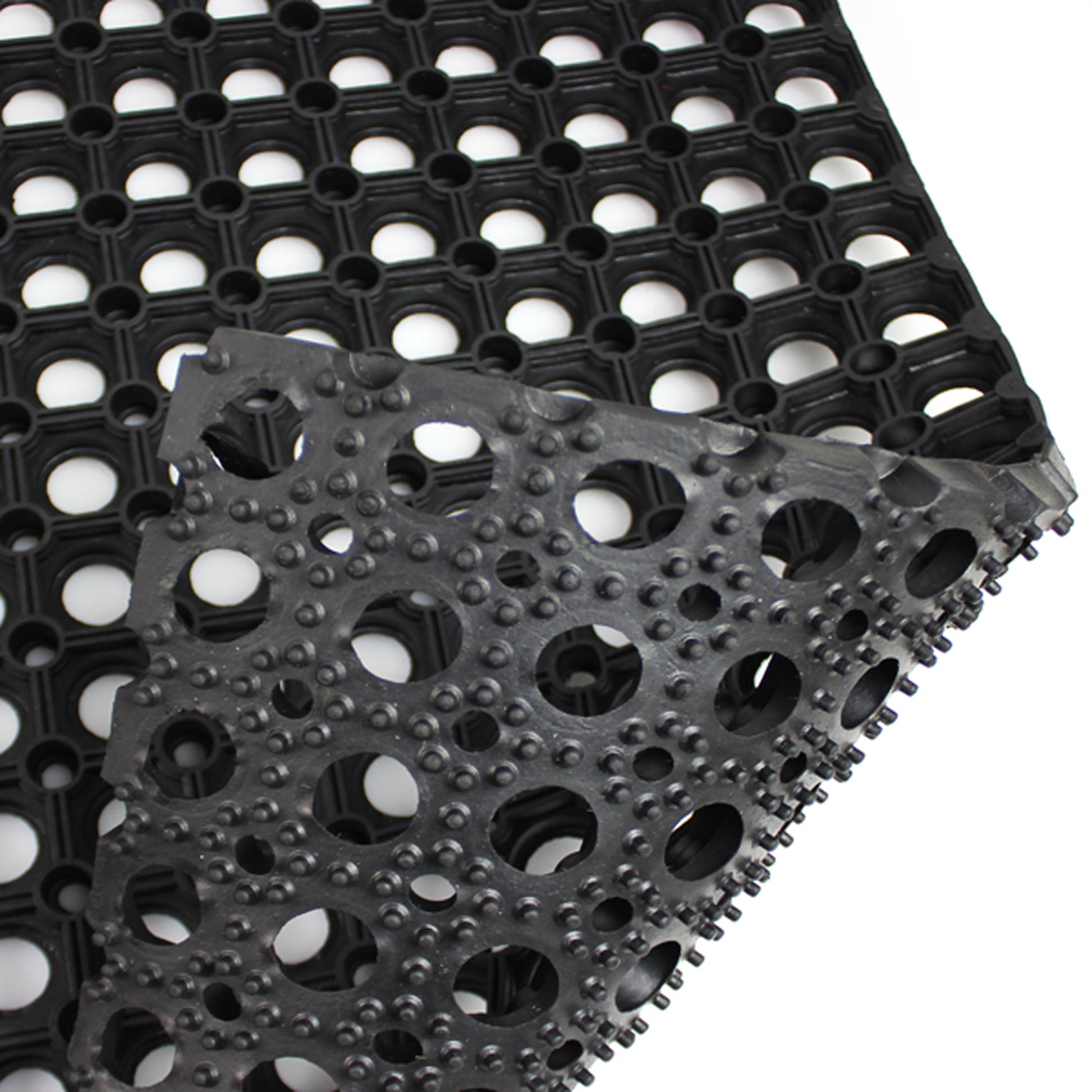 Black textured mat with circular patterns on a white background