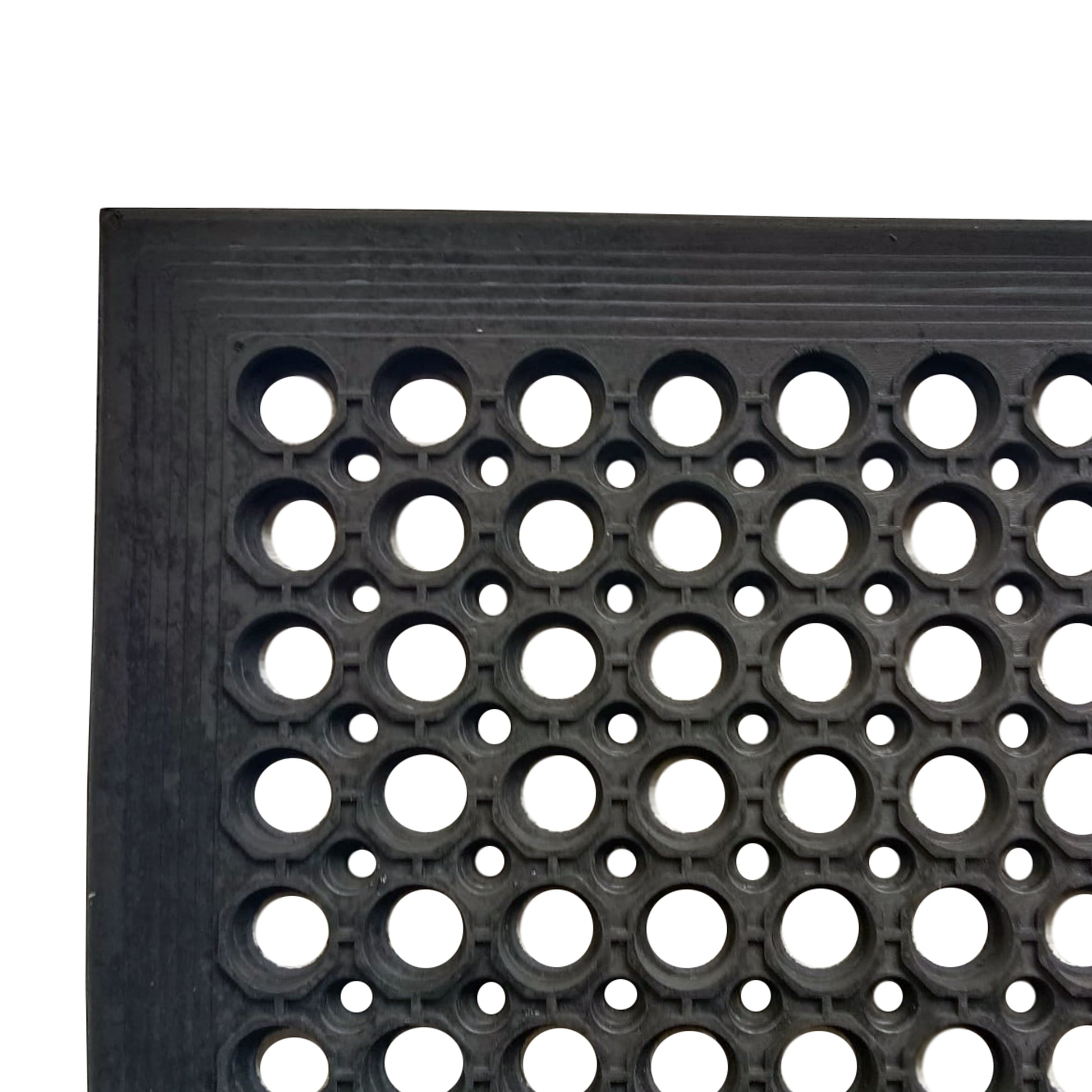 Close-up view of the corner of the All Weather Outdoor Entrance Mat with durable black honeycomb pattern