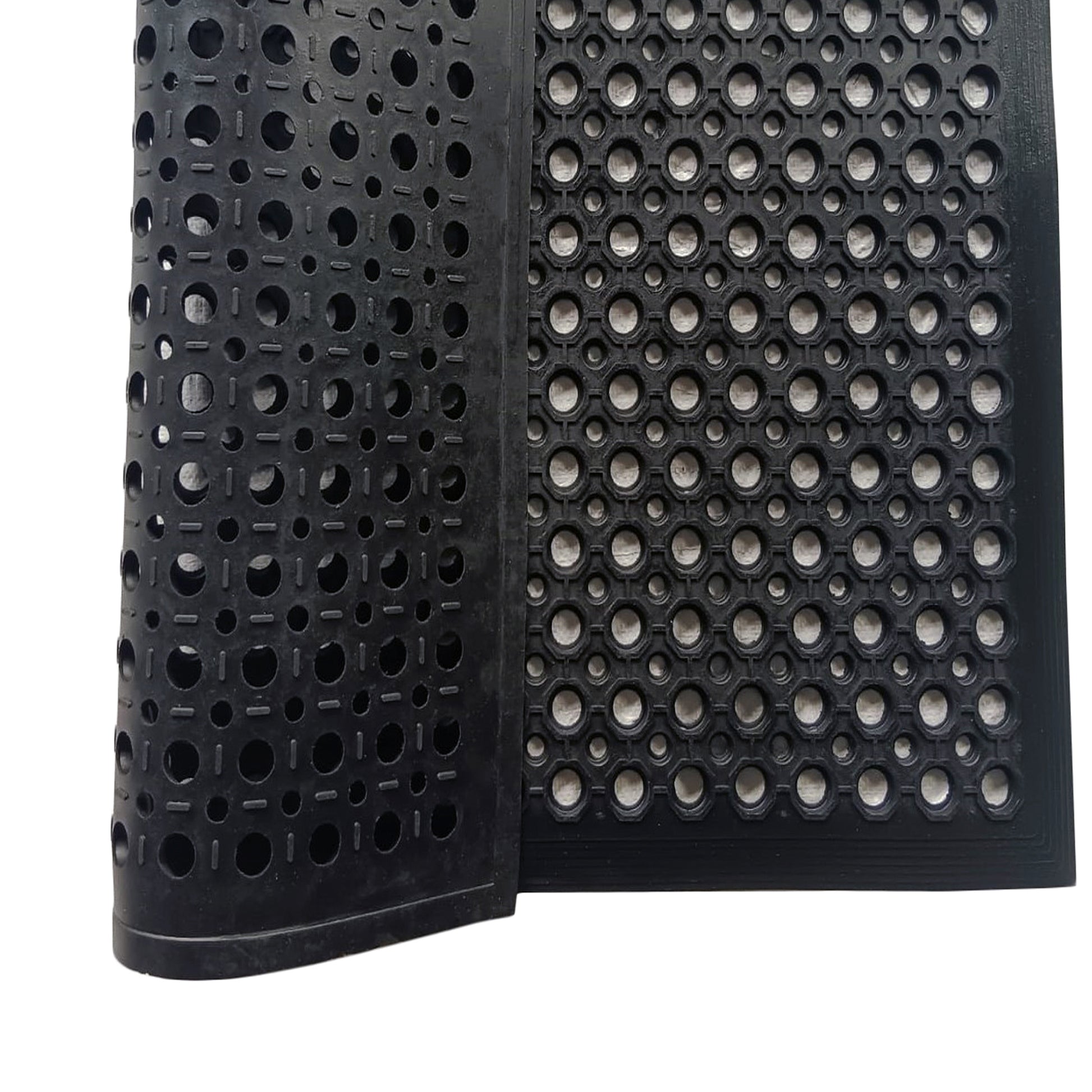 Close-up of a black textured mat with circular patterns on a white background