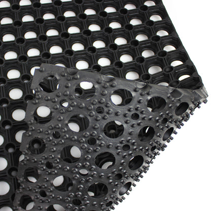 Black textured mat with circular patterns on a white background