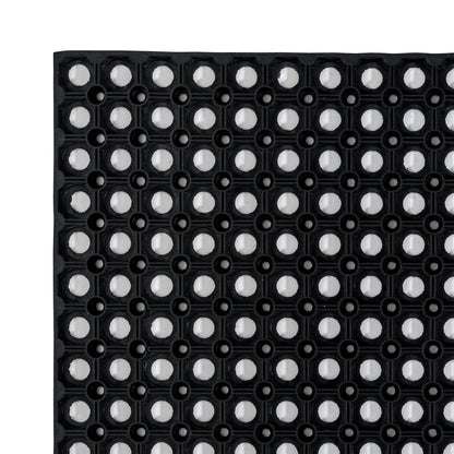 A detailed closeup of the Hometex All Seasons Outdoor Entrance Mat, a black  textured mat with circular patterns