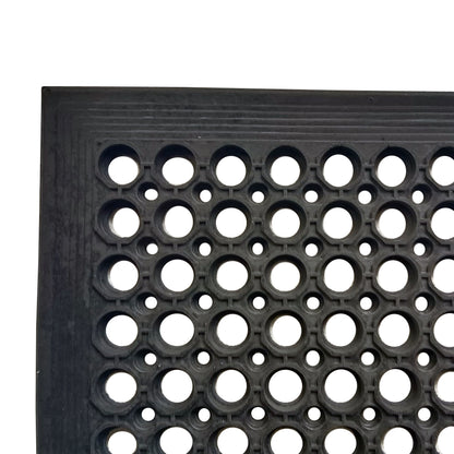 Close-up view of the corner of the All Weather Outdoor Entrance Mat with durable black honeycomb pattern