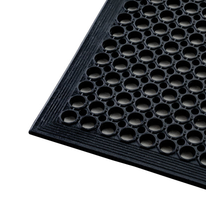 Close-up view of the corner of the All Weather Outdoor Entrance Mat with durable black honeycomb pattern