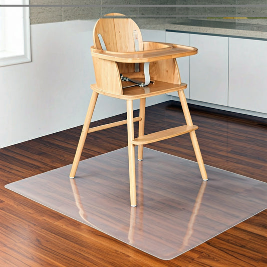 A clear vinyl universal floor protector mat under a wooden high chair on a hardwood floor.